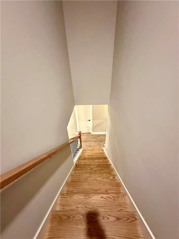 stairs with baseboards and wood finished floors