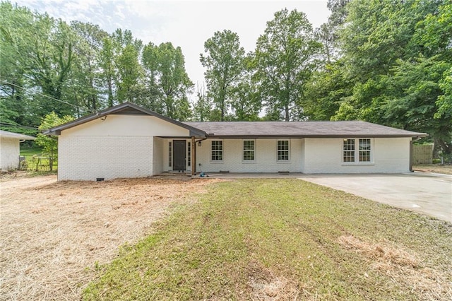 ranch-style home with brick siding, a front yard, and concrete driveway