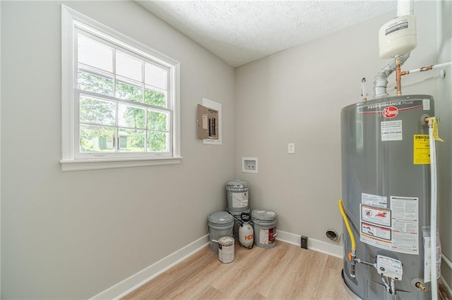 utility room featuring gas water heater and electric panel
