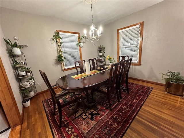 dining space featuring hardwood / wood-style floors, plenty of natural light, and a notable chandelier