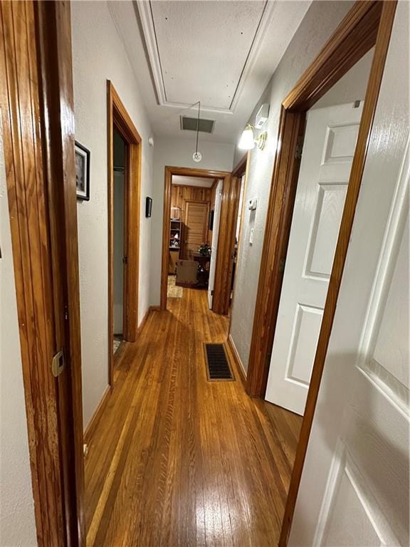 hall with hardwood / wood-style flooring