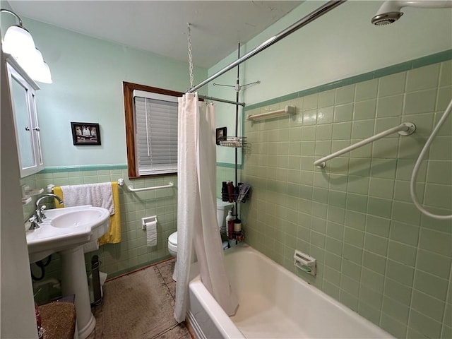 bathroom with tile patterned floors, toilet, tile walls, and shower / tub combo with curtain