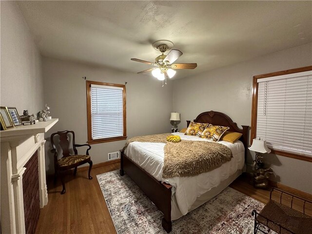 bedroom featuring ceiling fan and dark wood-type flooring