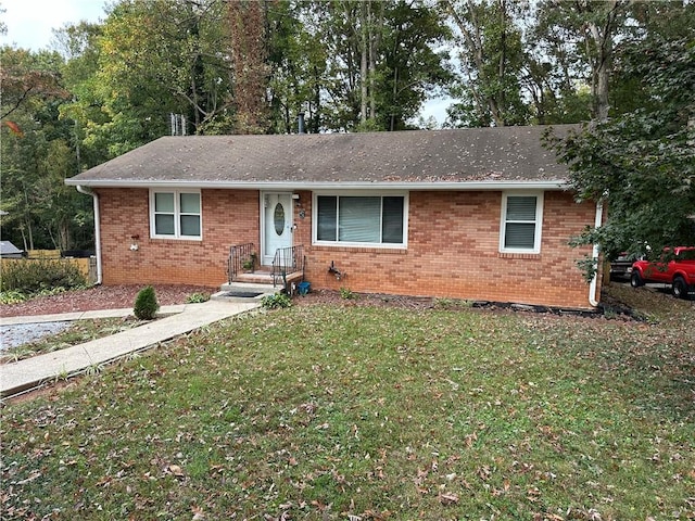 ranch-style home with a front lawn