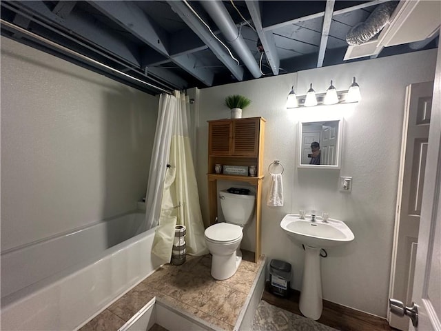 bathroom with hardwood / wood-style flooring, shower / bath combo, and toilet