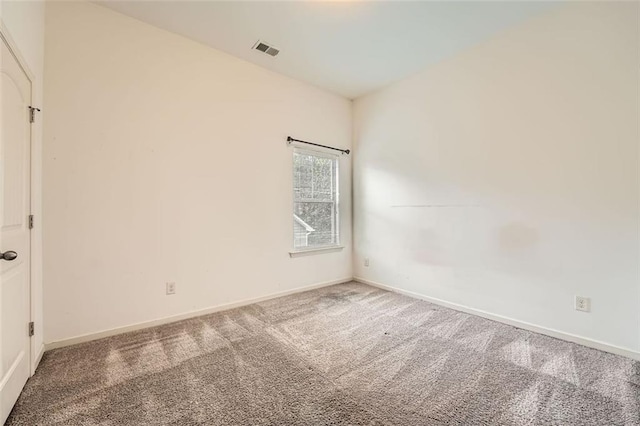 spare room featuring visible vents, baseboards, and carpet