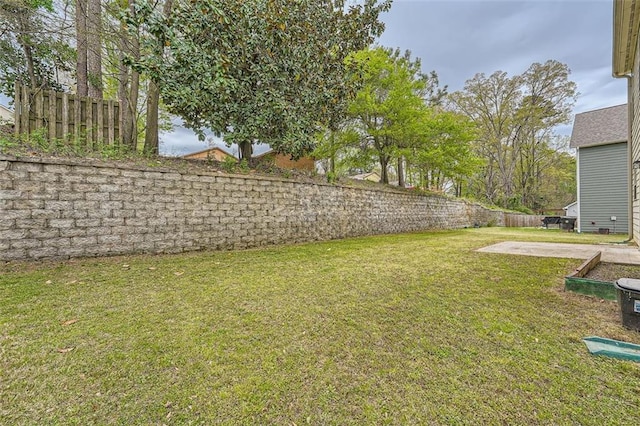 view of yard featuring fence and a patio