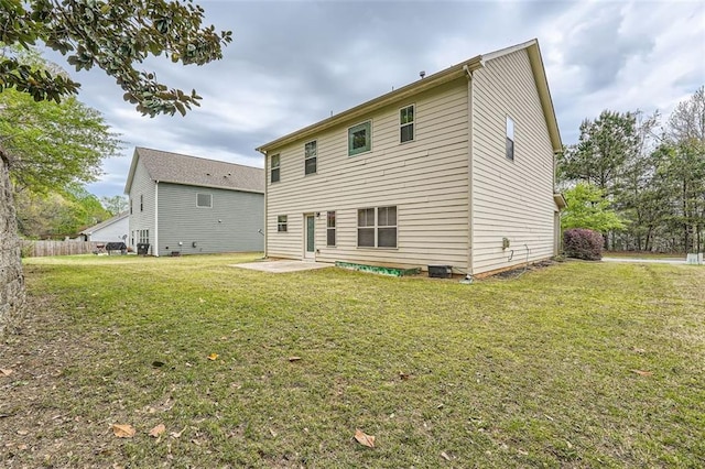 back of property featuring a patio and a lawn
