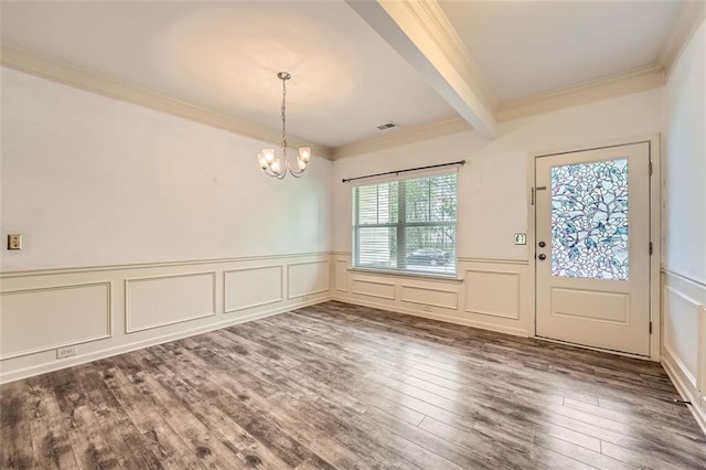 entryway featuring an inviting chandelier, beamed ceiling, crown molding, and wood finished floors