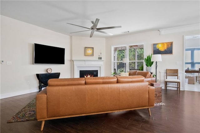 living room featuring dark hardwood / wood-style flooring and ceiling fan