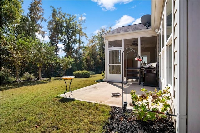 view of yard with a sunroom and a patio