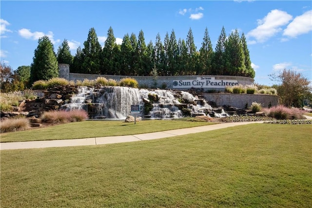 view of property's community with a lawn