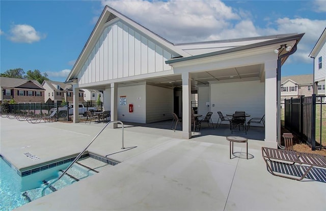 view of patio featuring fence, a residential view, and outdoor dining space