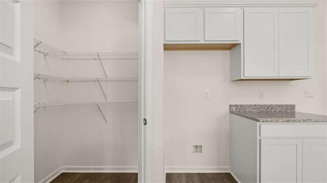 interior space with baseboards and dark wood finished floors