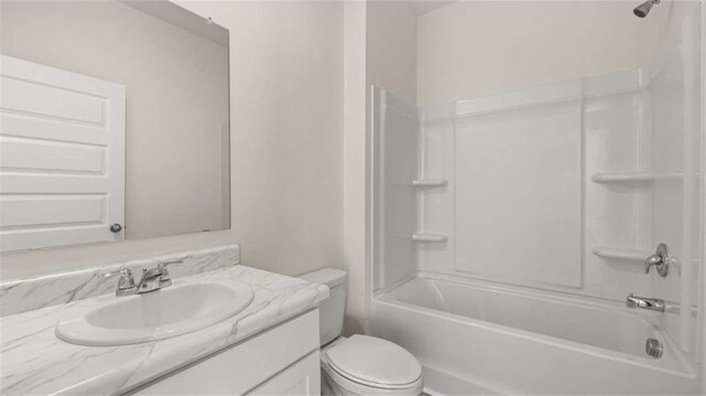 full bathroom featuring toilet, vanity, and  shower combination