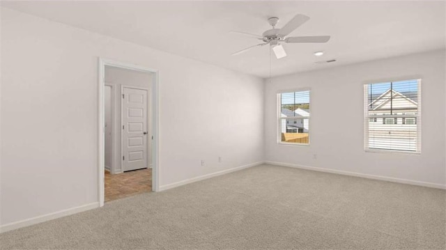 empty room with light carpet and ceiling fan