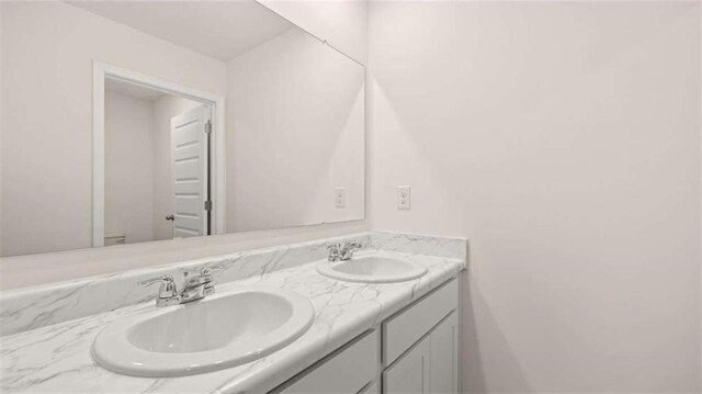 bathroom featuring a sink and double vanity