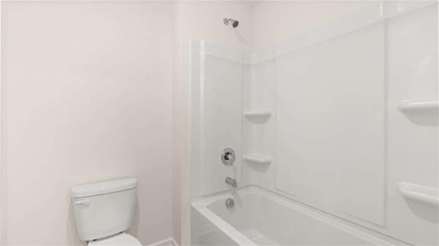 bathroom featuring shower / washtub combination and toilet