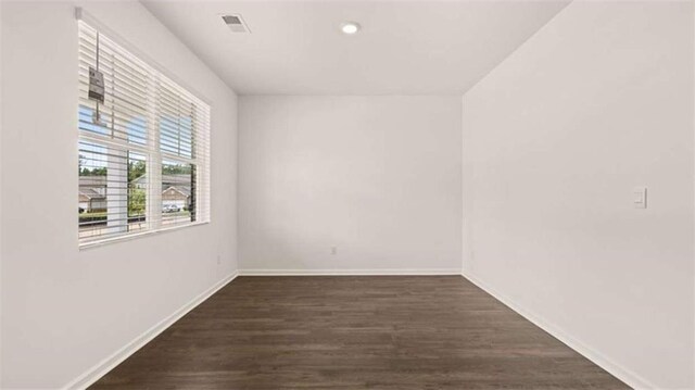 unfurnished room featuring visible vents, baseboards, recessed lighting, and wood finished floors