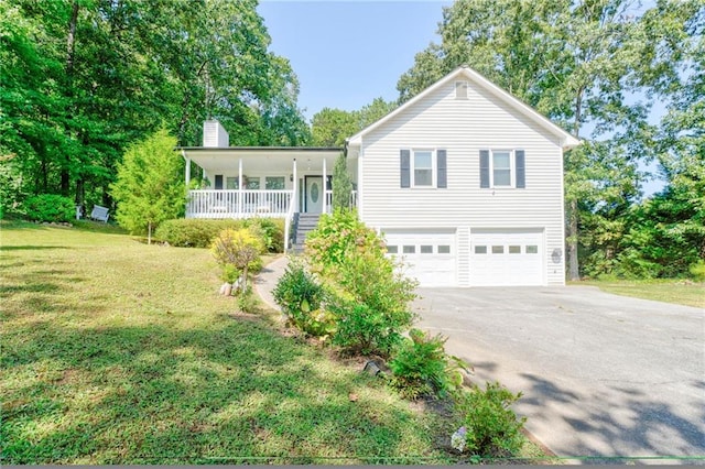 view of front facade featuring a garage, a porch, and a front lawn