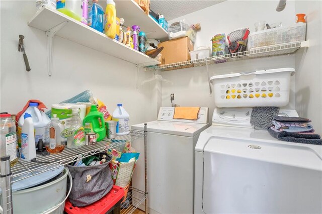 laundry room with separate washer and dryer and a textured ceiling