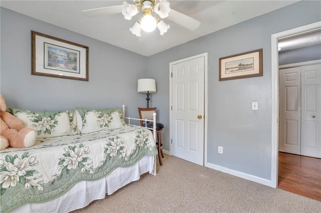 bedroom with a closet, ceiling fan, and carpet flooring