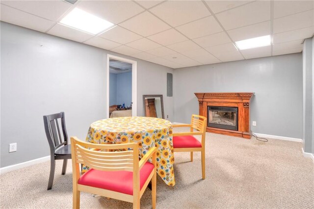 dining room featuring a paneled ceiling and carpet