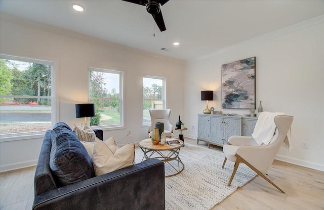 living area featuring crown molding, baseboards, ceiling fan, recessed lighting, and wood finished floors