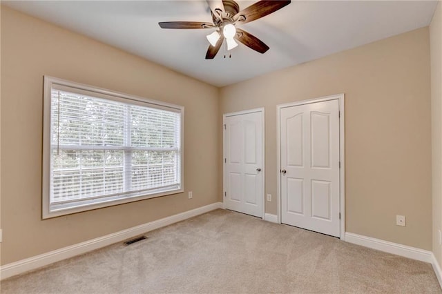 39 Legendary Dr, Hoschton, GA 30548 - unfurnished bedroom with light carpet and ceiling fan