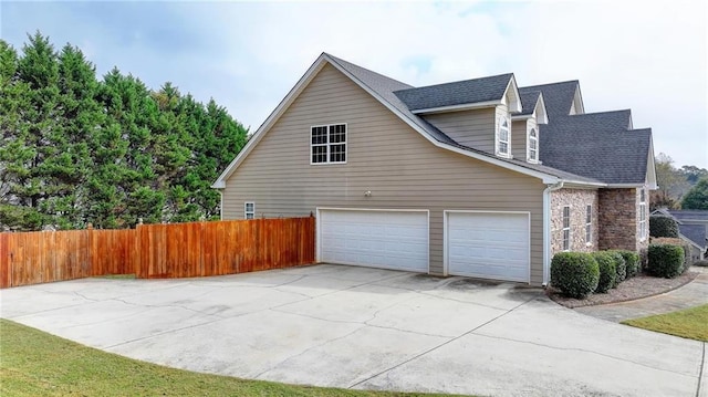 39 Legendary Dr, Hoschton, GA 30548 - view of side of home with driveway and roof with shingles