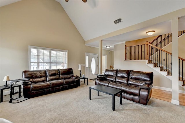 39 Legendary Dr, Hoschton, GA 30548 - carpeted living area with stairs, high vaulted ceiling, and ceiling fan
