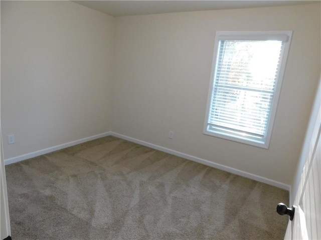 carpeted spare room with baseboards