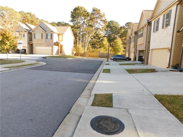 view of street featuring sidewalks, a residential view, and curbs