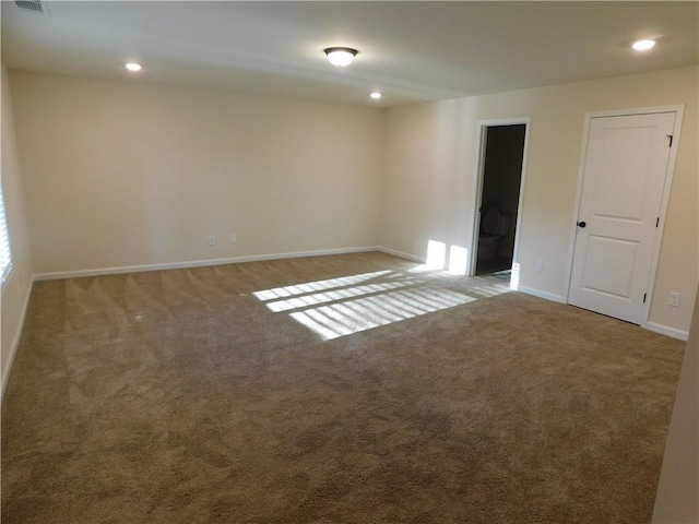 unfurnished room with carpet floors, recessed lighting, visible vents, and baseboards