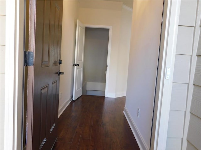 hall with dark wood-style floors and baseboards