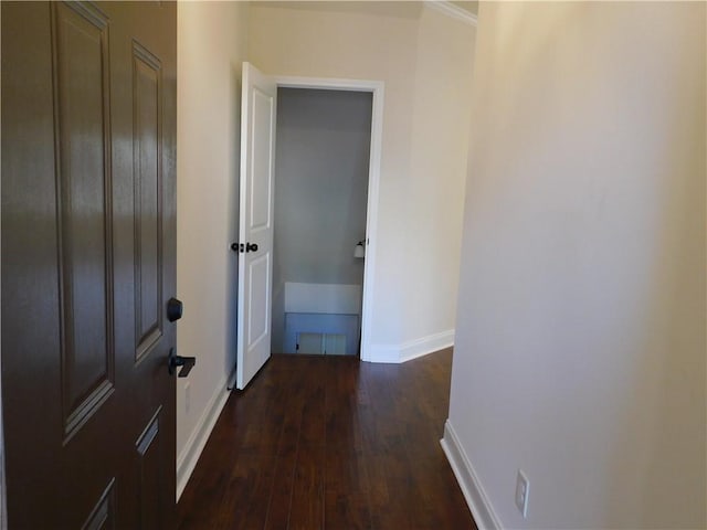 hallway with baseboards and dark wood finished floors