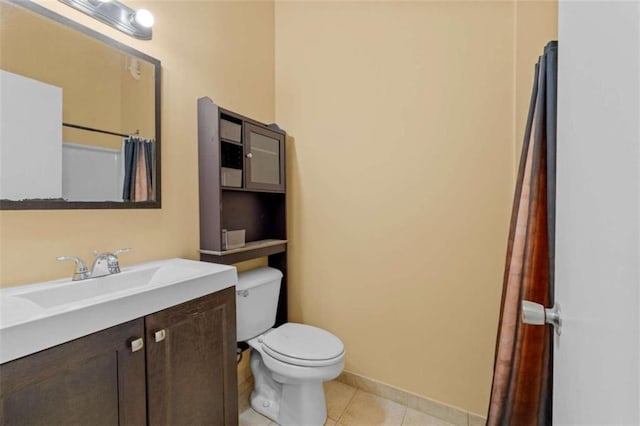 bathroom with vanity, toilet, and tile patterned flooring