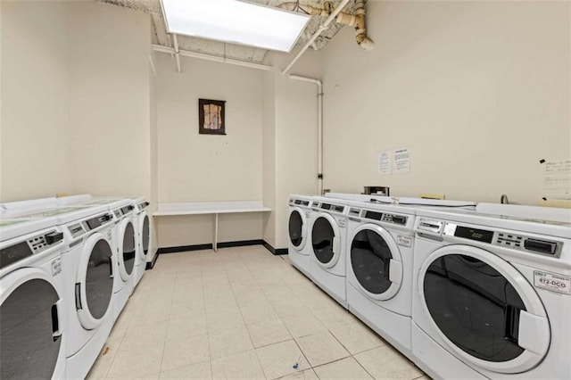 washroom featuring washing machine and clothes dryer and light tile patterned flooring