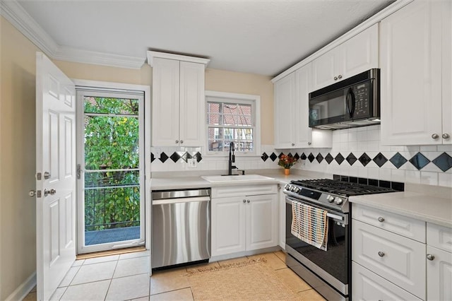 869 Briarcliff Rd NE Unit B20, Atlanta, GA 30306 - kitchen with appliances with stainless steel finishes, a sink, decorative backsplash, light tile patterned floors, and light countertops