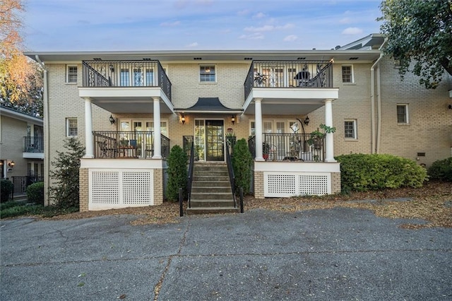 869 Briarcliff Rd NE Unit B20, Atlanta, GA 30306 - view of front of house with a balcony, covered porch, and brick siding