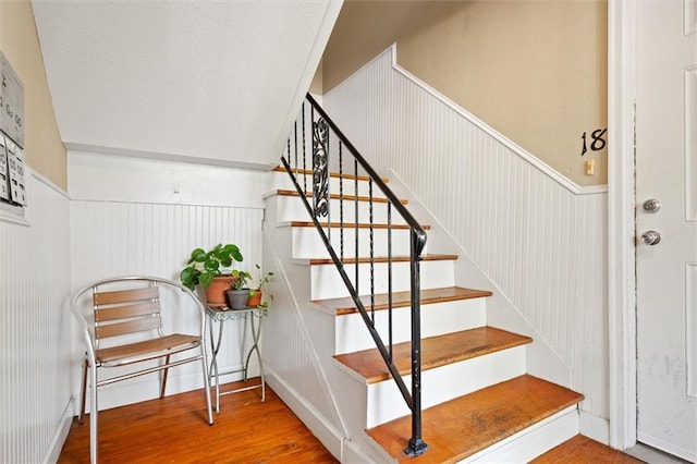 869 Briarcliff Rd NE Unit B20, Atlanta, GA 30306 - stairway featuring wood finished floors, a wainscoted wall, and a decorative wall