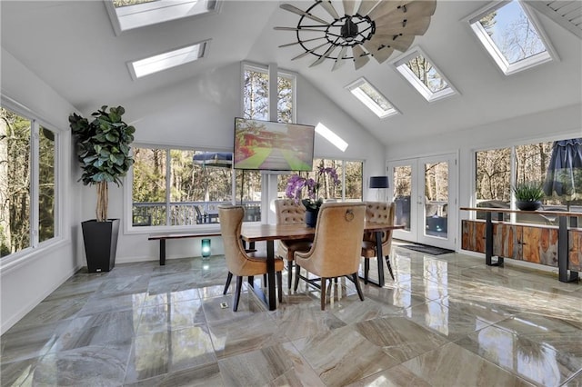 dining room with high vaulted ceiling and french doors