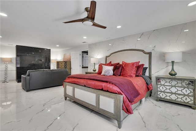 bedroom featuring ceiling fan and tile walls