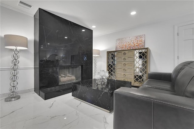 interior space featuring ornamental molding and a high end fireplace