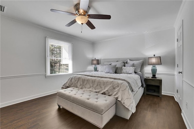 bedroom featuring crown molding, dark wood-type flooring, and ceiling fan