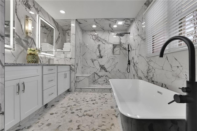 bathroom featuring vanity, plus walk in shower, and tile walls