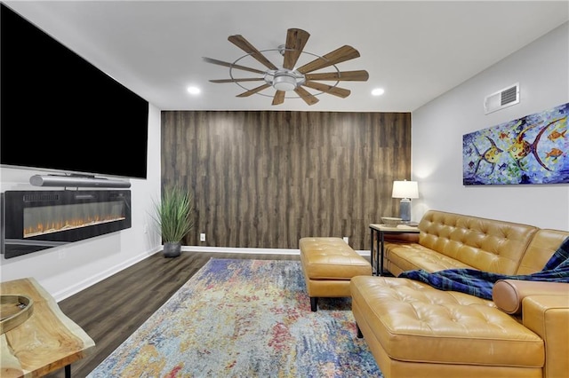 living room with dark hardwood / wood-style flooring and ceiling fan