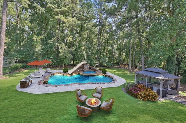 view of swimming pool with a gazebo, a lawn, a patio area, and a fire pit