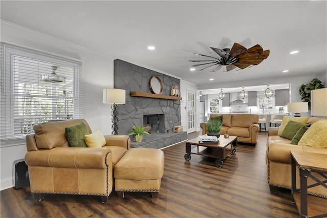 living room featuring crown molding, hardwood / wood-style floors, and a fireplace