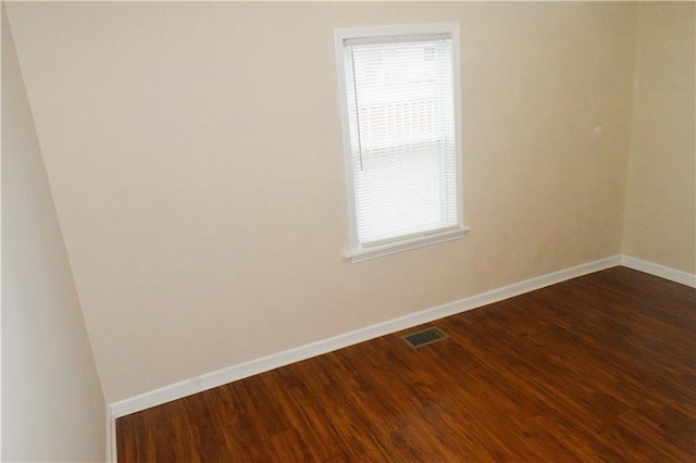 unfurnished room featuring dark hardwood / wood-style floors